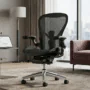 Lumbar Support Resistance Measured -A professional-grade black mesh ergonomic office chair with a reinforced lumbar support system, displayed in a modern, well-lit living room setting for high-end furniture analysis.