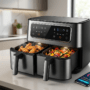 Air Fryers With Dual-Zone Sync -A modern black smart air fryer with dual-zone sync capability, simultaneously cooking crispy chicken wings in one basket and roasted vegetables in the other, next to a smartphone displaying the control app on a kitchen counter.