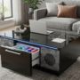 A modern living room featuring the Sobro Smart Coffee Table. The coffee table is sleek black with a glass top. One of the refrigerator drawers is slightly open, revealing cold drinks inside. On the other side, built-in Bluetooth speakers are integrated into the base. Subtle LED lighting glows beneath the table. The table is surrounded by a comfortable gray sectional sofa and is placed on a textured rug, creating a warm and contemporary atmosphere. A few items like a tablet and a small plant are on the tabletop.